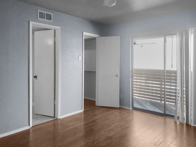 unfurnished room with light wood-type flooring