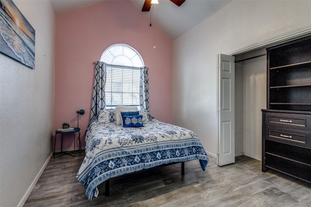 bedroom featuring high vaulted ceiling, hardwood / wood-style floors, and ceiling fan