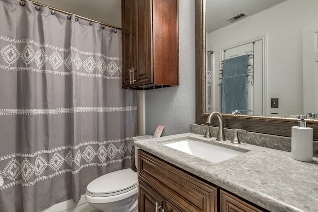 bathroom featuring toilet and vanity