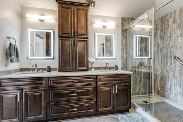 bathroom featuring vanity and a shower with door