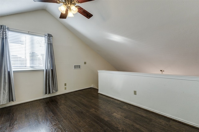 additional living space with lofted ceiling, dark wood-type flooring, and ceiling fan