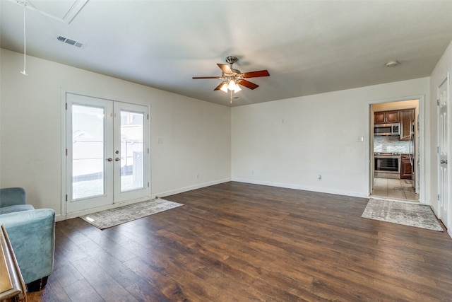 unfurnished living room with french doors, dark hardwood / wood-style flooring, and ceiling fan