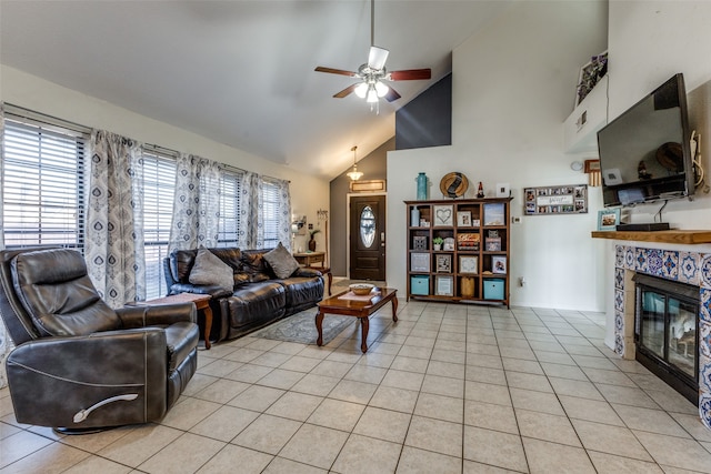 living room with high vaulted ceiling, light tile patterned floors, ceiling fan, and a fireplace