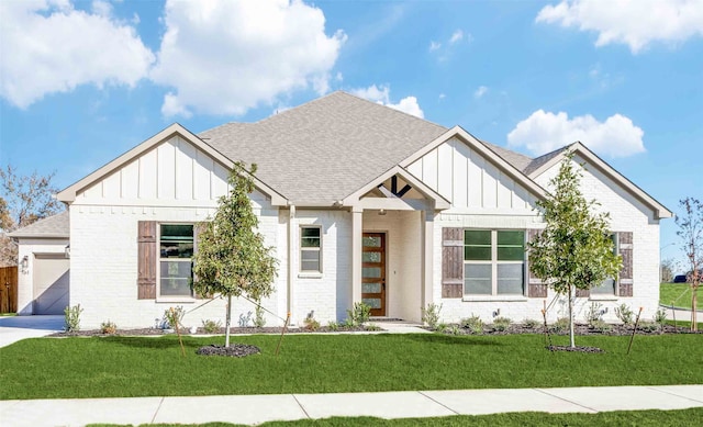 view of front of home with a garage and a front lawn