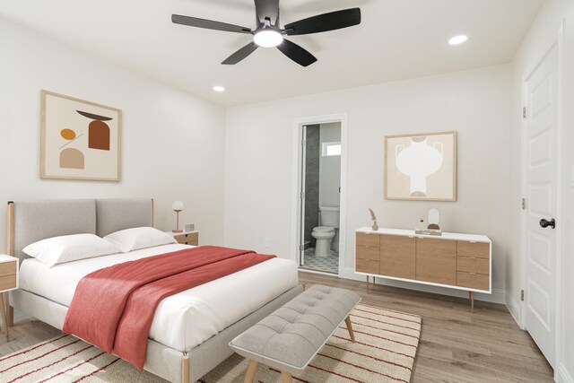 bedroom with hardwood / wood-style flooring, ceiling fan, and connected bathroom