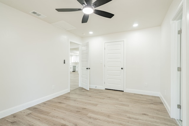 empty room with ceiling fan and light wood-type flooring