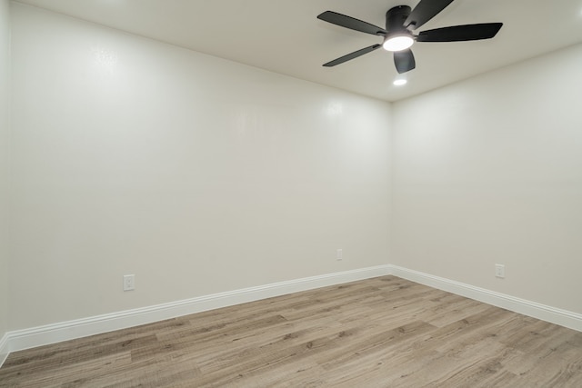 spare room featuring ceiling fan and light hardwood / wood-style flooring