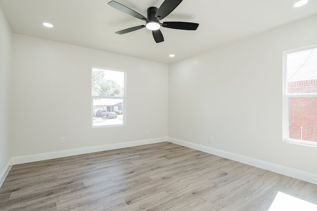 unfurnished room with light hardwood / wood-style flooring, a wealth of natural light, and ceiling fan