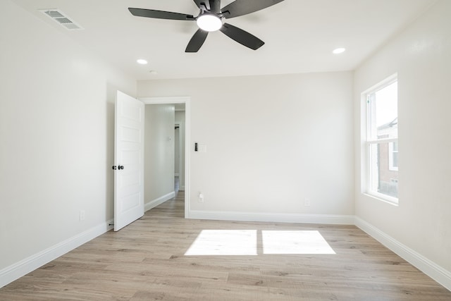 empty room with ceiling fan and light hardwood / wood-style floors