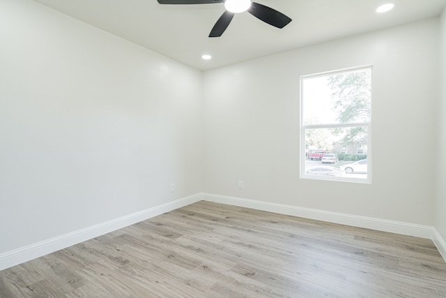 empty room with ceiling fan and light hardwood / wood-style floors