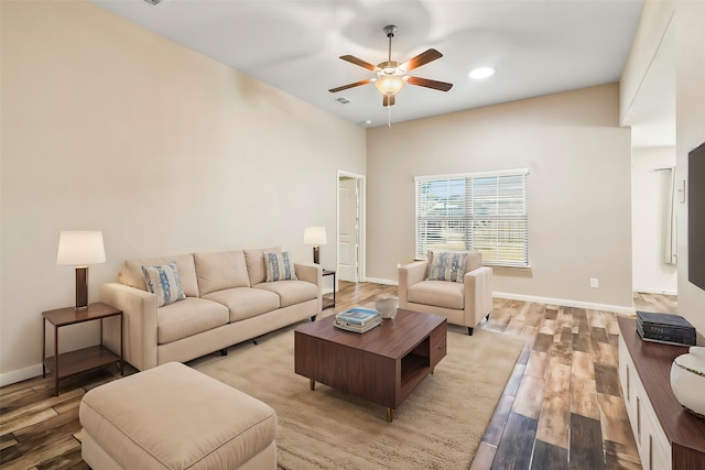 living room featuring ceiling fan and light wood-type flooring