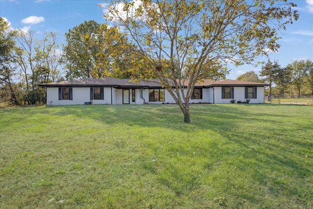 rear view of house featuring a lawn