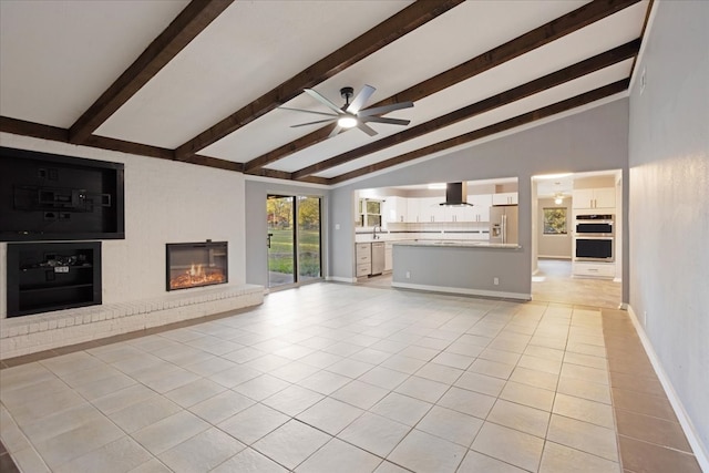 unfurnished living room with lofted ceiling with beams, a fireplace, light tile patterned flooring, and ceiling fan