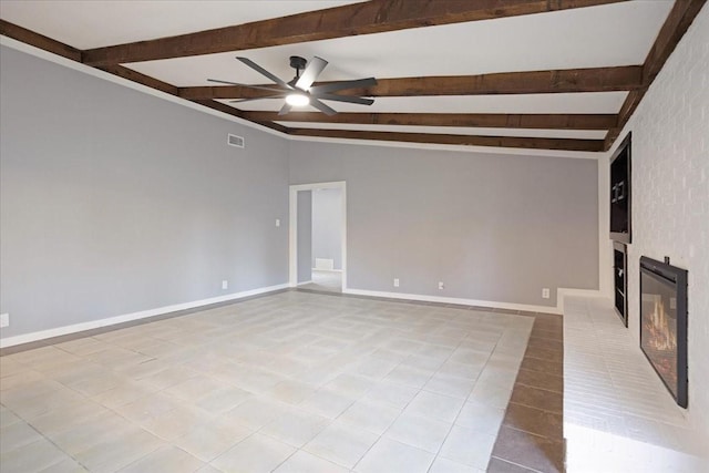 unfurnished living room featuring visible vents, vaulted ceiling with beams, baseboards, a glass covered fireplace, and a ceiling fan