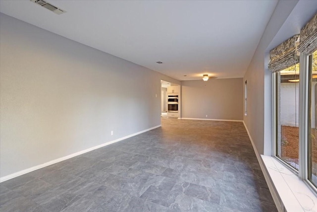 spare room featuring visible vents and baseboards