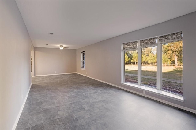 unfurnished room with visible vents, baseboards, and concrete flooring
