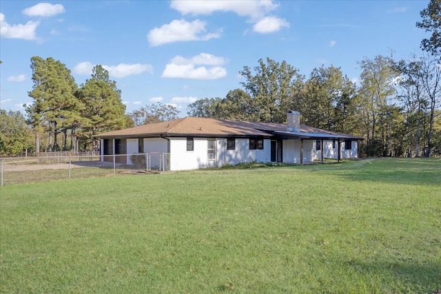 back of property featuring a yard