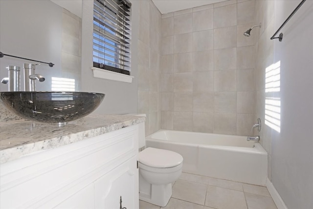 full bathroom featuring vanity, tile patterned floors, toilet, and tiled shower / bath combo