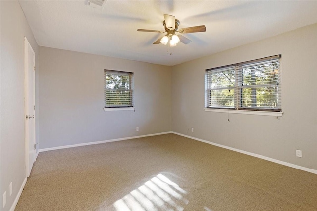 unfurnished room featuring ceiling fan, carpet, and baseboards