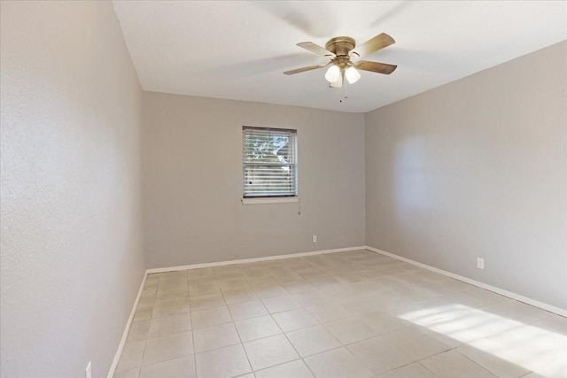 empty room featuring baseboards and ceiling fan