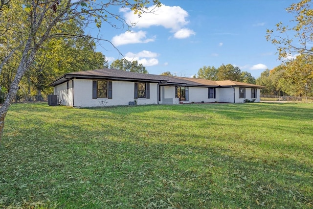 ranch-style home with central AC unit and a front yard