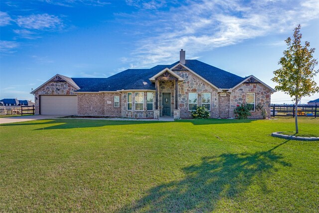 view of front of house with a garage and a front lawn