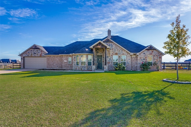 view of front of house with a garage and a front lawn