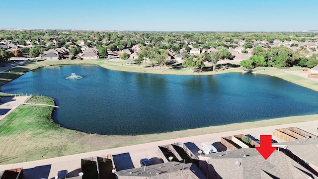 drone / aerial view featuring a water view and a residential view