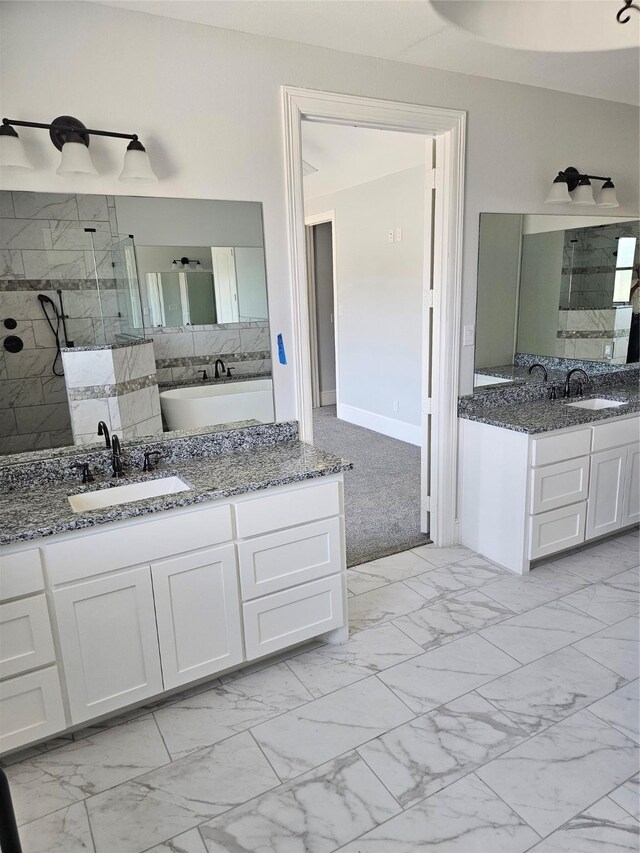 bathroom featuring vanity and tiled shower