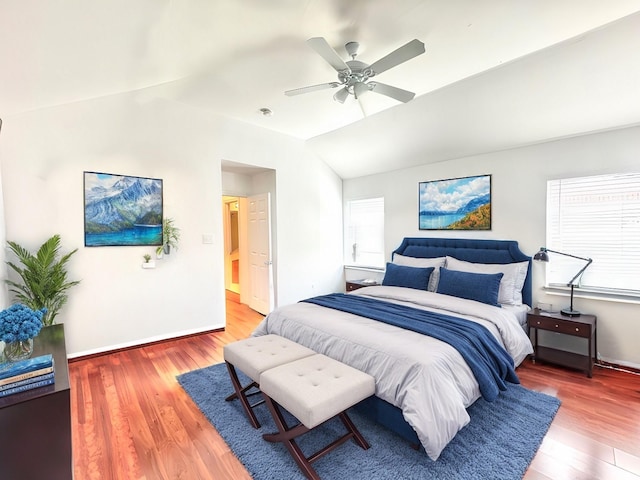 bedroom featuring ceiling fan, hardwood / wood-style flooring, and lofted ceiling