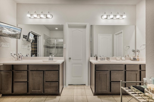 bathroom with tile patterned flooring, vanity, and a shower with shower door