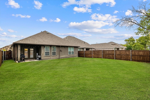 rear view of property with a lawn and french doors