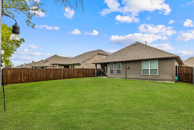 rear view of house featuring a lawn