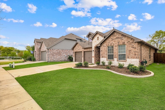 view of front of property with a garage and a front lawn