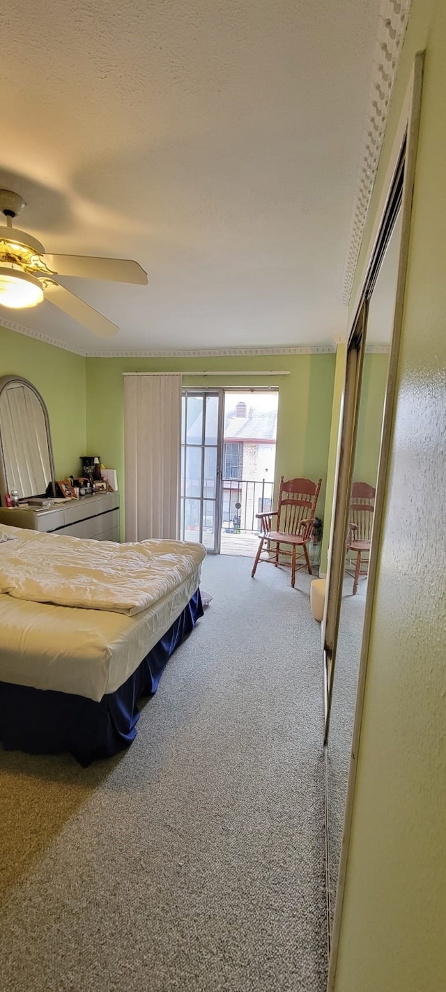 bedroom featuring access to outside, ceiling fan, a closet, and carpet