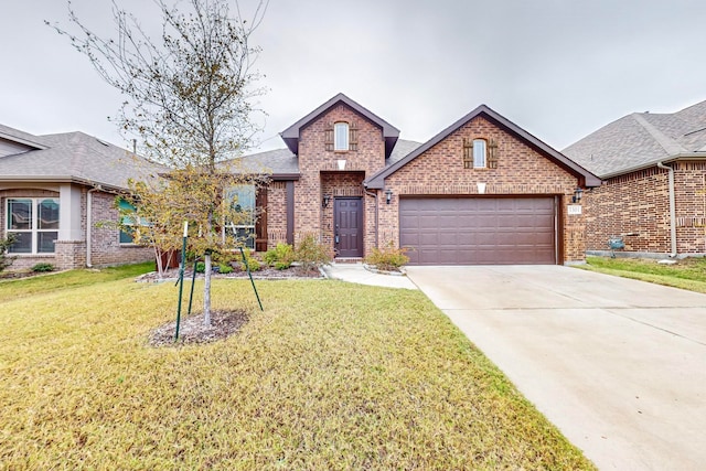 view of front of property with a front lawn and a garage