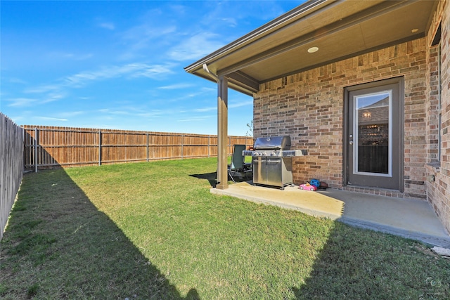 view of yard with a patio area and a fenced backyard