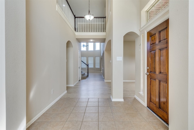 tiled foyer featuring a high ceiling