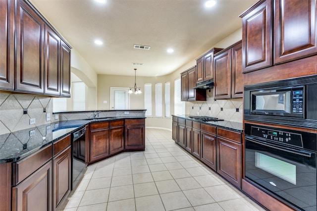 kitchen with decorative backsplash, hanging light fixtures, black appliances, a chandelier, and dark stone countertops