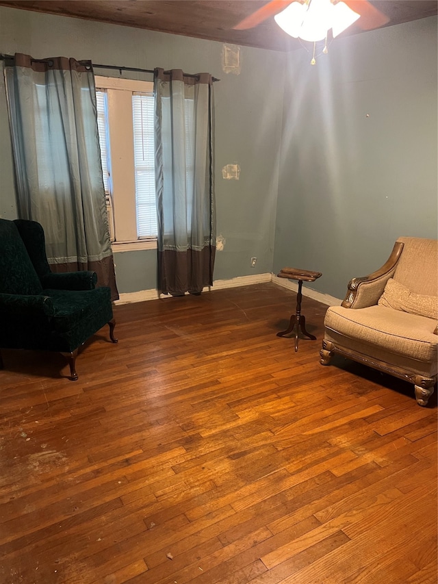 sitting room with hardwood / wood-style floors and ceiling fan