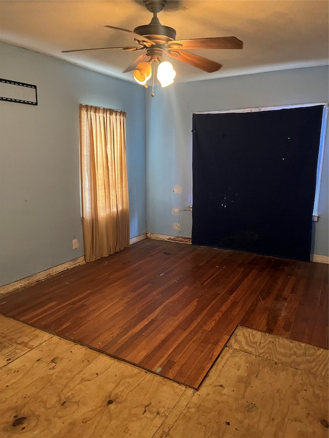 empty room with ceiling fan and wood-type flooring