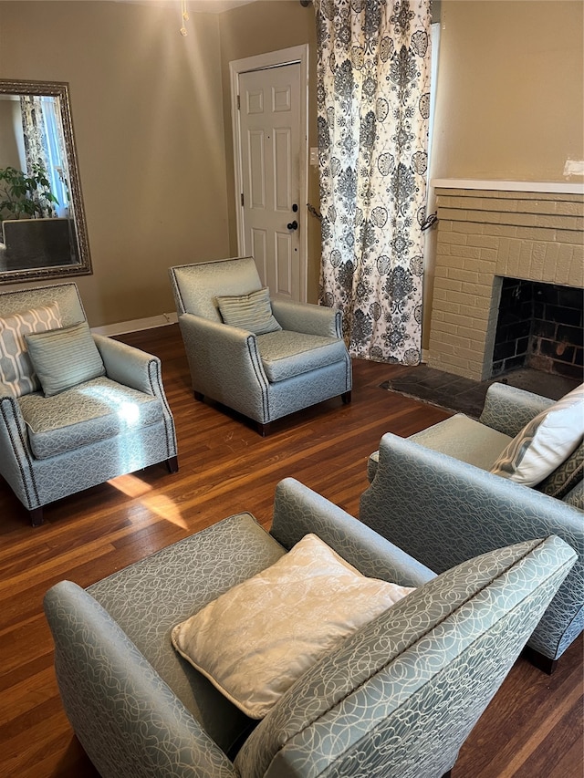 living room with a fireplace and dark wood-type flooring