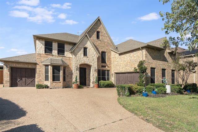 view of front of home featuring a front yard and a garage