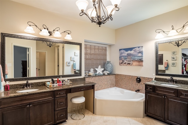 bathroom featuring a tub to relax in, tile patterned flooring, vanity, and a chandelier