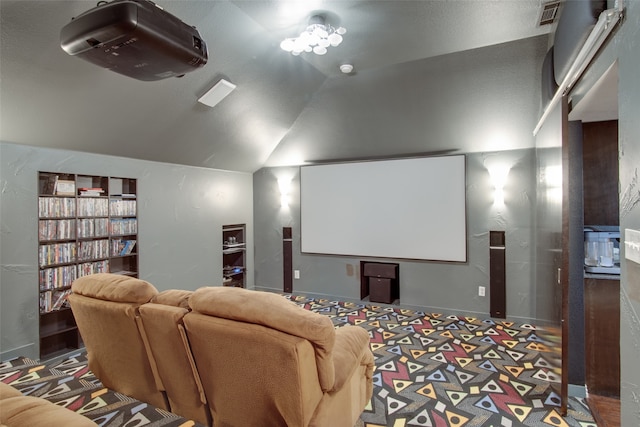 cinema room featuring vaulted ceiling