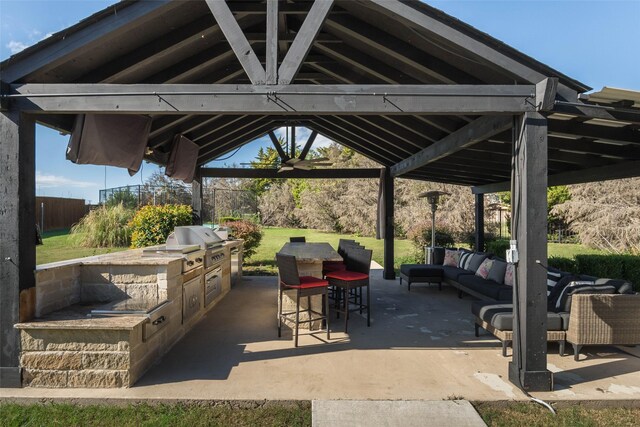 view of patio / terrace with area for grilling, an outdoor living space, ceiling fan, a gazebo, and grilling area