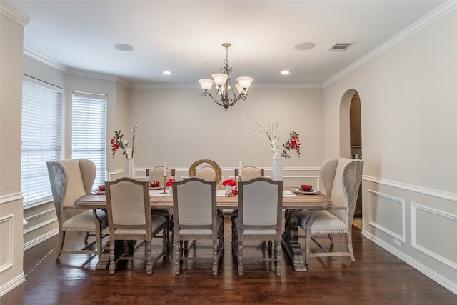 dining area with dark hardwood / wood-style flooring, crown molding, and plenty of natural light