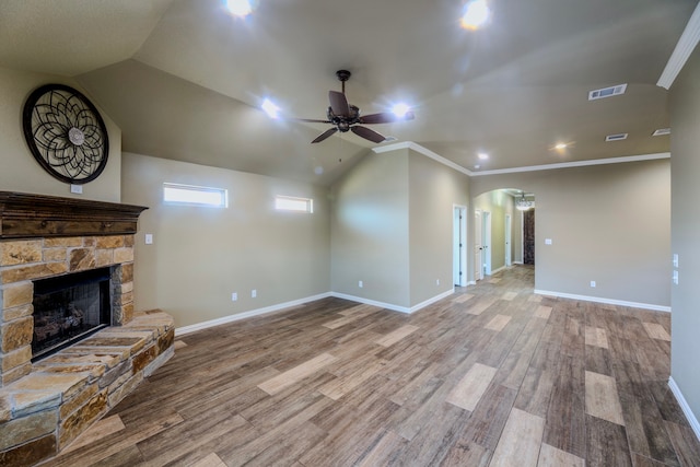 unfurnished living room with a fireplace, light hardwood / wood-style floors, vaulted ceiling, and ornamental molding