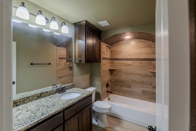 full bathroom with tiled shower / bath, toilet, vanity, and wood-type flooring