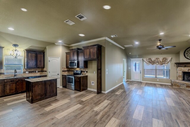 kitchen featuring a center island, pendant lighting, light hardwood / wood-style floors, and stainless steel appliances